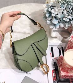 Description CHRSTN DR Saddle Bag Cedar Green Grained Canvas Spring For Women 20cm/8in CD Rep 1:1 Measurements: 19.5 x 6.5 x 16 cm / 8 x 2.5 x 6 inches The iconic Saddle bag is reinvented once more by Maria Grazia Chiuri. Featuring a Saddle flap with a magnetic ‘D’ stirrup clasp, it boasts a ‘CD’ signature on each side of the handle. The black ultramatte calfskin style is embellished with tonal metal hardware. The Saddle bag may be carried by hand or worn over the shoulder and can be customized w Christian Dior Saddle Bag, Engagement Goals, Louis Vuitton Shirt, Chanel Shirt, Dior Saddle, Book Tote Bag, Gold Luxury, Maria Grazia Chiuri, Maria Grazia