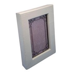 a white frame with a purple window on the front and bottom side, in an ornate pattern