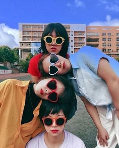 three young people with sunglasses on their heads