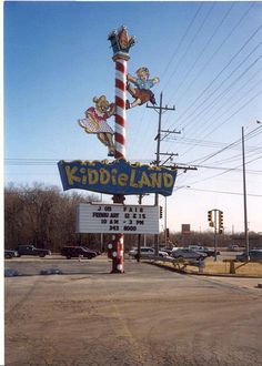 a sign for kiddie land in the middle of an empty lot