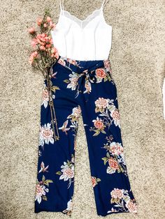 Imagine your most favorite lounge pants, then dress them up a bit with a belt and a beautiful floral pattern. That is exactly how these beach pants feel!! These pants feature wide legs for maximum comfort, an elastic waist in the back and a floral tie in the front paired with the most perfect dark navy color. Perfect for your beach getaway or for lounging around looking fab! Sizing and Fit Length : S 41", M 41", L 41" Inseam : S 29", M 29", L 29" Waist : S 24", M 26", L 28" Hips : S 44", M 45", Flower Pants Outfit, Floral Pants Outfit, Leopard Jumpsuit, Flirty Outfits, Flower Pants, Perfect Dark, Corporate Style, Beach Getaway, Beach Outfits