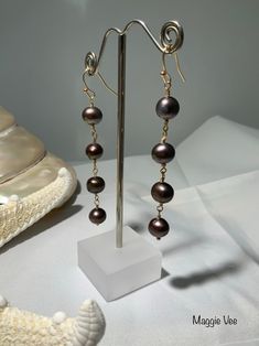 "Beautiful Black Tahitian Pearls strung on Gold-filled wires make a stunning pair of earrings.   These exquisite pearls that I used will go with whatever you are wearing . Pearls measure 9.60mm .  These dangle approximately 3\" from the gold-filled earring wires. *The earrings in the picture are the ones you will receive." Gold Tahitian Pearl Earrings Gift, Tahitian Pearl Dangle Earrings Gift, Tahitian Pearl Drop Jewelry With Round Beads, Gold Tahitian Pearl Drop Earrings, Tahitian Pearl Drop Earrings, Black Tahitian Pearls, Tahitian Black Pearl Necklace, Wearing Pearls, Black Pearl Earrings