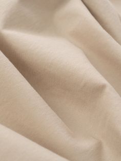 a close up view of a plain beige fabric