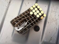 a bunch of empty wine bottles sitting on top of a metal shelf next to a bottle opener