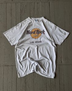 FOLLOW MY SHOP TO CHECK DAILY UPDATES & PRICE DROPS Vintage Men's Hard Rock Cafe Las Vegas Tee Shirt White Short sleeve crew neck heavyweight cotton tee shirt. Big graphic print with Hard Rock Cafe logo on the front on the chest. Size XL P2P - 22'' Length - 30'' Shirt is in very good pre-owned condition and has minor flaw. Please check pictures for more information on the product Shipping options: - standard shipping in 7-15 days - priority in 3-5 business days (price will be more)   Check out my other items & follow - new arrivals every week! If you have any questions regarding the item, shipping - feel free to contact any time. All items are genuine. Customer satisfaction is our priority! Cafe Logo, Rock Cafe, Hard Rock Cafe, Shirt White, Hard Rock, Favorite Things Gift, Vintage Men, White Shorts, Tee Shirt