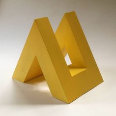 a small yellow object sitting on top of a white table