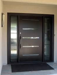 a modern entry door with glass panels and sidelights on the front of a house