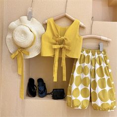 Introducing our must-have summer ensemble for stylish young girls - the backless top with matching long bloomers in Polka Dot, completed with a trendy Sun Hat. Designed with comfort and style in mind, this outfit is perfect for the warm summer days ahead. The backless top features a vibrant mustard color, giving it a playful and fashionable appeal. Its unique tie-up detail at the back adds an extra touch of charm, allowing for easy adjustments and a perfect fit. Paired with the adorable long blo Print Outerwear, Balloon Pants, Girls Vest, Girls Top, Backless Top, Hat Set, Girls Clothing Sets, Easy Breezy, Ribbon Tie