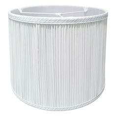 a white lamp shade with pleated fabric