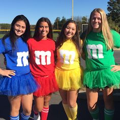 four girls are dressed up in colorful costumes