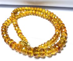 two bracelets made out of yellow glass beads