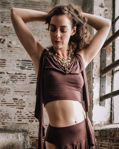 The Kayleigh Tendril Crop Top is a super soft stretch modal tank crop top, with boho tendrils that flow and drape and can be draped over the body in different ways. ***Listing is for top only.Made to order.  Front cowl necklineLong tendrils with raw edgesTop-stitched seamlinesSIZESSMALL (size 4-6) bust 34-36MEDIUM (size 8-10) bust 37-38LARGE (size 12-14) bust 39-41LAUNDRY CAREGentle wash cold in a delicates bag, Tumble dry low, Remove promptly, Hang to dry. Warm iron inside out when damp.Purchas Sleeveless Stretch Dancewear Tops, Stretch Tank Halter Top For Yoga, Fitted Camisole Top For Yoga, Fitted Yoga Camisole Top, Stretch Tops For Dance, Fitted Tank Halter Top For Yoga, Bohemian Fitted Tops With Built-in Bra, Bohemian Tops With Built-in Bra And Fitted Style, Bohemian Tops With Built-in Bra