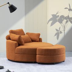 an orange couch and ottoman in front of a wall with a plant shadow on it