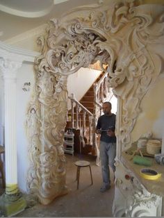 a man standing in front of a white archway