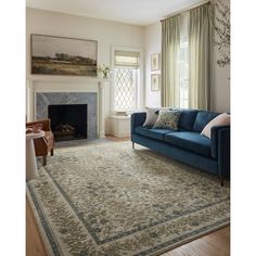 a living room filled with furniture and a fire place in front of a painting on the wall