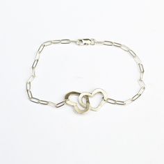 "Your heart and my heart are very very old friends" - Hafez This bracelet has 2 cutout hearts linked together on a petite clip chain bracelet. Linked hearts symbolize love for yourself, the world, another person. It is the perfect gift for a friend, loved one, or romantic partner. Bracelet measures 7 1/4" at longest length and may be clasped shorter at any link --Retail purchases are shipped in a custom Chocolate and Steel card and a jewelry box perfect for gift giving and storing your jewelry. Personalized Sterling Silver Heart Friendship Bracelet, Sterling Silver Friendship Bracelets For Valentine's Day, Sterling Silver Bracelets For Valentine's Day, Sterling Silver Heart Bracelet For Mother's Day And Friendship, Hypoallergenic Sterling Silver Heart Bracelet For Friendship, Sterling Silver Heart Bracelet For Friendship, Elegant Sterling Silver Heart Bracelet For Friendship, Sterling Silver Bracelets With Heart Charm For Friendship, Sterling Silver Heart Bracelet With Adjustable Chain For Anniversary