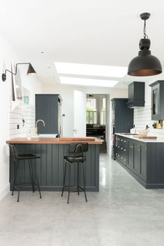 a large kitchen with two bar stools in it