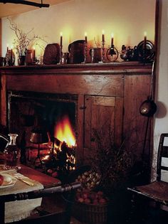 an old fireplace with candles lit in it