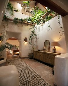 an indoor living room with plants growing on the walls and ceiling, along with furniture