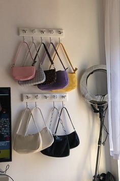 several purses are hanging on the wall