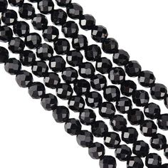 black faceted glass beads are lined up together