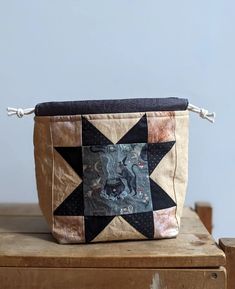 a small bag sitting on top of a wooden table