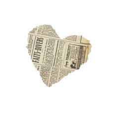 an old newspaper heart cut out into the shape of a paper