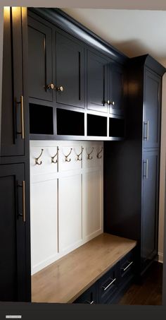 a black and white mud room with built - in lockers, cabinets and drawers