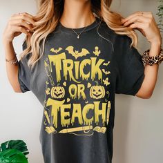 🎃 Trick or Teach - Halloween Teacher Shirt 🎃 Check out more Halloween shirts in our shop https://www.etsy.com/shop/KITONICZA?ref=dashboard-header&section_id=44946946 Get ready to "trick or teach" in style with this vibrant Comfort Colors Halloween teacher shirt! Perfect for adding some spooky flair to your classroom or Halloween festivities, this shirt is ideal for any teacher who loves to bring fun and festive vibes to their wardrobe. Whether you're handing out candy or lesson plans, this com Spooky Halloween Shirt With Letter Print, Yellow Graphic Print T-shirt For Halloween, Fall Teacher Gifts, Trick Or Teach Shirt, Halloween Teacher Memes, Halloween Yellow Graphic Print T-shirt, Halloween Teacher Gifts, Teacher Halloween, Trick Or