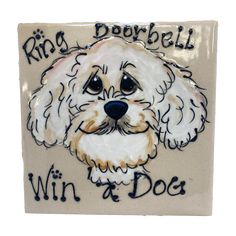 a ceramic tile with a white dog's face and words written on it that says, ring dorbell win a dog