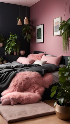 a bedroom with pink walls and plants in pots on the floor, along with a large bed