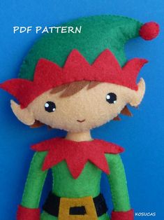 an elf doll is wearing a green and red outfit