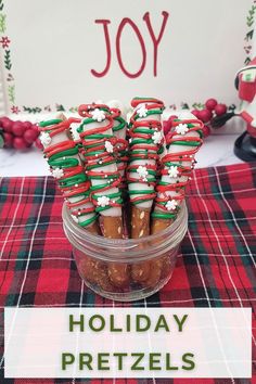 pretzel rods decorated for the holidays in a mason jar