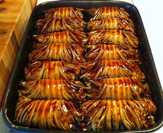 a pan filled with lots of food sitting on top of a counter