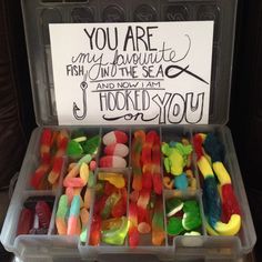 a plastic container filled with lots of gummy bears and a sign that says you are my favorite fish in the sea