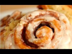 cinnamon rolls with icing on a white plate