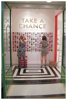 two women are standing in front of a display