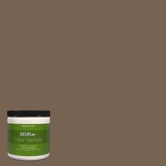 a jar of marquee paint on a green background