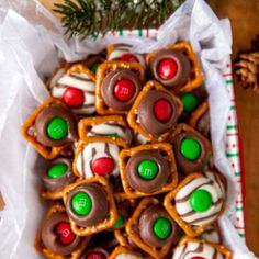 christmas pretzels with m and m candy on them in a paper wrapper