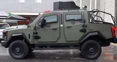 an army vehicle is parked on the street