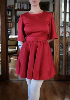 This is a 100% cotton full skirt with elaticated waist in red. The skirt is made out of a beautiful high quality cotton sateen - this fabric has a suble sheen giving it a luxurious look. The fabric is thick, soft and has a little bit of stretch to it making it very comfortable to wear. This is a versatile garment as the skirt can be easily dressed up with a top or worn with a jumper for a more casual look. The lenght of the skirt is approximately 44cm (17''). Shown here with the red cotton sateen full circle skirt.  This item here is in size S and the model's height is 165cm (5′4″).  If you would the to lenghten or shorten the hem please let me know - it is easy to do to! Available sizes (see size chart in photos): XXS, XS, S, M, L, XL, XXL.  Current production time is up to 2 weeks. Red Flared Cotton Skirt, Red Cotton Flared Skirt, Cotton Mini Dress With Gathered Skirt, Red Fitted Skirt With Elastic Waistband, Full Circle Skirt, Full Circle Skirts, Skirt Mini, Full Circle, Look Plus