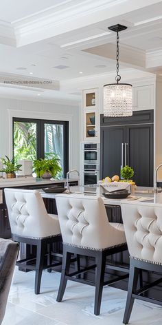 a large kitchen with an island and bar stools next to it, along with two sinks