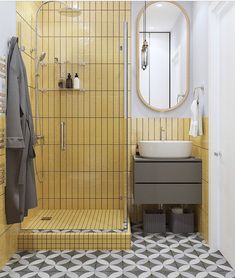 a yellow tiled bathroom with a sink, mirror and towel rack on the wall next to the shower