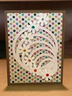 a card with white flowers and dots on it