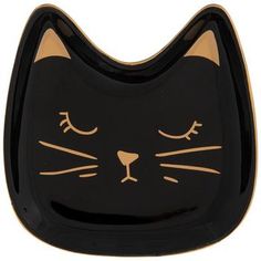 a black and gold cat shaped plate with eyes closed