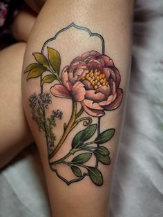 a woman's thigh with flowers and leaves on it