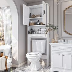 a white toilet sitting in a bathroom next to a sink