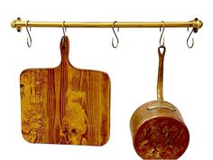 two wooden cutting boards hanging on a metal bar