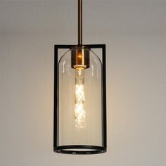 a light fixture hanging from the ceiling with a clear glass cover on it's side