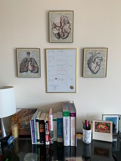 a desk with books and pictures on the wall